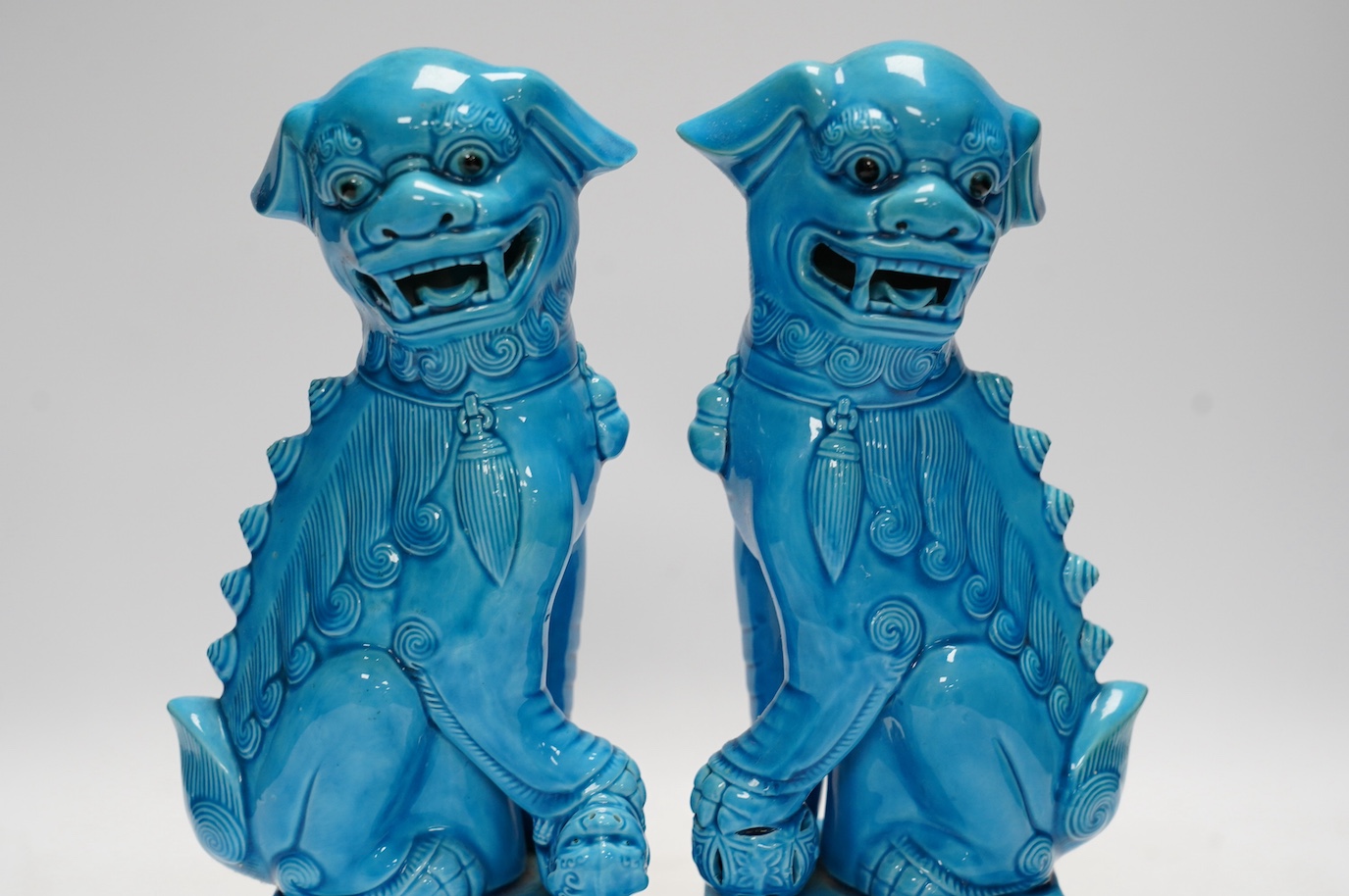 A pair of Chinese turquoise glazed lion dogs, 29cm. Condition - good